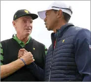  ?? ANDY BROWNBILL — THE ASSOCIATED PRESS ?? Internatio­nal team captain Ernie Els, left, shakes hands with U.S. team player and captain Tiger Woods after the U.S. team won the President’s Cup golf tournament at Royal Melbourne Golf Club in Melbourne, Sunday. The U.S. team won the tournament 16-14.