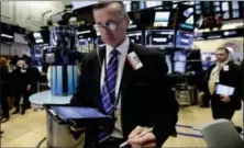  ?? RICHARD DREW — THE ASSOCIATED PRESS ?? Trader Neil Catania works on the floor of the New York Stock Exchange, Wednesday. Stocks are opening solidly higher on Wall Street, led by gains in technology companies.