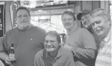  ?? | MITCH DUDEK/SUN-TIMES ?? Loyalties are divided at Schooners tavern in downstate Bloomingto­n, where Mike Svob (second from left) supports the Cubs while (from left) Randy Crutcher, Bob Groetken, Kurt Kartke and Rich Groetken root for the Cardinals.