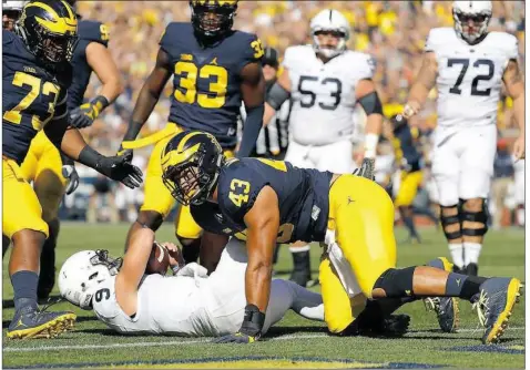  ?? Leon Halip/Getty Images ?? Michigan’s Chris Wormley sacks Penn State quarterbac­k Trace McSorley Saturday — one of six sacks for the Wolverines in their 49-10 rout of the Nittany Lions in Ann Arbor, Mich.
