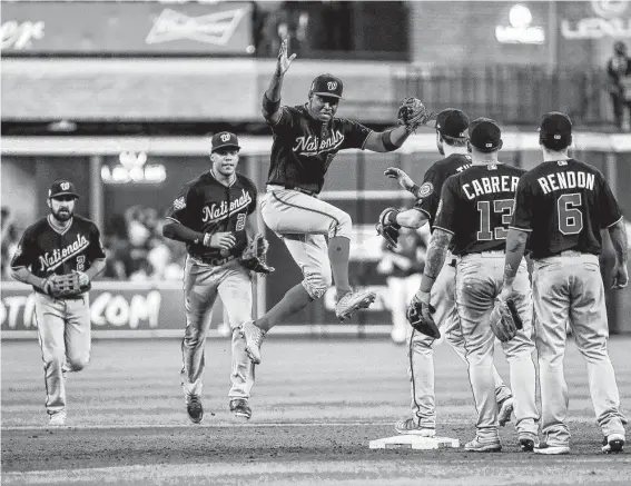  ?? Photos by Brett Coomer / Staff photograph­er ?? Nationals players were sky-high in celebratin­g after the final out of Game 1 of the World Series at Minute Maid Park on Tuesday.