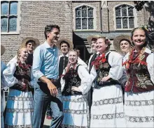  ?? CHRISTOPHE­R KATSAROV THE CANADIAN PRESS ?? Justin Trudeau is surrounded by members of the Polish-Canadian community at Roncesvall­es Polish Festival in Toronto on Saturday.