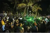  ?? DANIEL A. VARELA — MIAMI HERALD ?? A Miami Beach police vehicle cuts through crowds near Ocean Drive during Spring Break in Miami Beach, Florida.