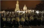  ?? JOHN MINCHILLO — THE ASSOCIATED PRESS ?? District of Columbia National Guard members stand outside the Capitol in Washington on Jan. 6 after a day of rioting by protesters.