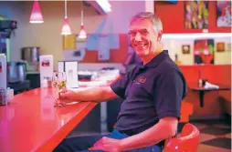  ??  ?? Roland Richter, who owns Joe’s Dining with his wife, Sheila Nixon, sits Tuesday at the counter of the restaurant on Rodeo Road. Although Joe’s has all the makings of a diner, the menu goes beyond what many might expect.