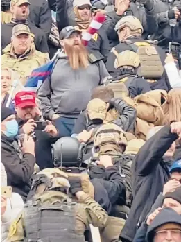  ?? ROBYN STEVENS BRODY ?? In an image from a video, a line of men walks up the U.S. Capitol stairs Jan. 6 in a “Ranger File,” a formation for a combat team to breach a building.