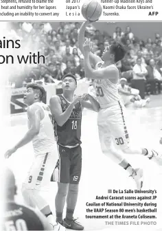  ?? AFP THE TIMES FILE PHOTO ?? De La Salle University’s Andrei Caracut scores against JP Cauilan of National University during the UAAP Season 80 men’s basketball tournament at the Araneta Coliseum.