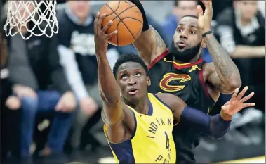  ?? TONY DEJAK / AP ?? Indiana Pacers’ Victor Oladipo drives to the basket in front of Cleveland Cavaliers’ LeBron James during the second half of Game 2 of their NBA Eastern Conference quarterfin­al on Wednesday in Cleveland. The Cavs won 100-97 to tie the best-of-seven...