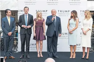  ?? EVAN VUCCI THE ASSOCIATED PRESS FILE PHOTO ?? President Donald Trump is joined by his family for the opening of the Trump Internatio­nal Hotel in Washington, D.C., in 2016. Trump says his business does not improperly accept gifts or payments.