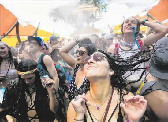  ?? Marcus Yam
Los Angeles Times ?? JOYOUS REVELERS
soak it all in during Day 1 of the Coachella Valley Music and Arts Festival on Friday in Indio. The second and final weekend begins this Friday.