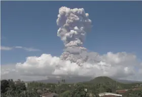  ?? Earl Recamunda / Associated Press ?? A column of ash shoots into the sky during the eruption of Mount Mayon as seen from Legazpi city, about 210 miles southeast of Manila in Albay province.