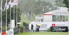  ?? ?? TIME TO PACK UP: A general view of the empty putting green during a weather delay yesterday.