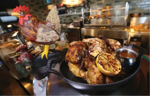  ?? VINCE TALOTTA PHOTOS/TORONTO STAR ?? A whole chicken with grilled lemon tempts at Union Chicken restaurant at Sherway Gardens. Each bird weighs about a kilogram and is fully steamed before hitting the rotisserie for 25 minutes.