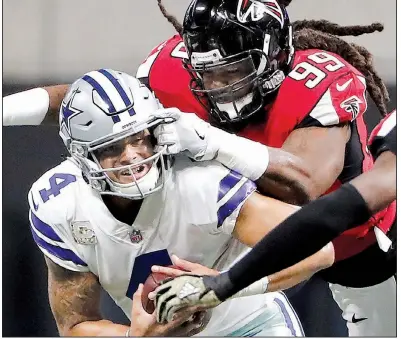  ?? AP/DAVID GOLDMAN ?? Falcons defensive end Adrian Clayborn sacks Dallas Cowboys quarterbac­k Dak Prescott during the first half of their game Sunday in Atlanta. The Falcons won 27-7 as Clayborn’s six sacks matched the second-most in NFL history.