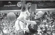  ?? Marco Garcia Associated Press ?? TJ HAWS of Brigham Young makes a pass around Chris Smith of UCLA in the first half.