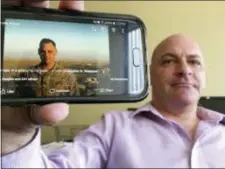  ?? MANUEL VALDES — THE ASSOCIATED PRESS ?? In this photograph taken Marine Corps veteran Chris Sheppard poses with a picture of himself taken during his service in Iraq in Oct. 2004, at his office in Seattle.