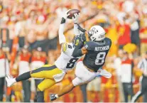  ?? MATTHEW PUTNEY/ASSOCIATED PRESS FILE PHOTO ?? Iowa defensive back Matt Hankins, left, makes an intercepti­on in front of Iowa State wide receiver Xavier Hutchinson during a Sept. 11 game in Ames, Iowa.