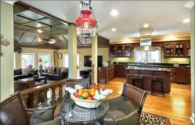  ??  ?? The family room, gourmet kitchen and casual dining area.