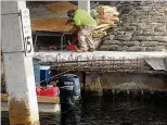  ?? PHOTO COURTESY OF NORTH PALM BEACH ?? Crews repair the Lighthouse Drive bridge in North Palm Beach, where the concrete and rebar were were in worse shape than the contractor originally thought.