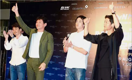  ??  ?? Looking ship-shape: The cast of ‘ The Battleship Island’ (from right) Song, So, Hwang and Ryoo greeting fans at Pavilion Kuala Lumpur.