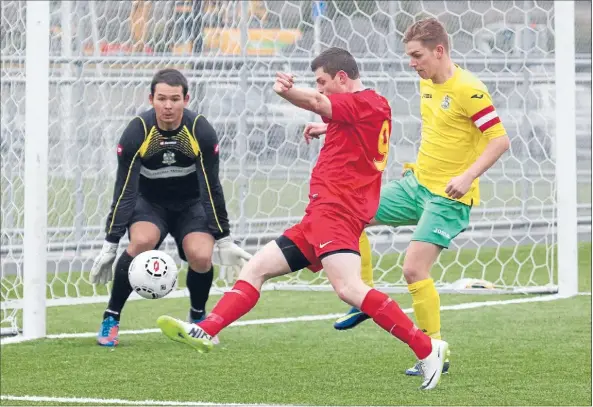  ?? Photo: CAM McINTOSH ?? Goal chance: Tawa’s Todd Painter (in red) looks to get a shot on target against Lower Hutt.