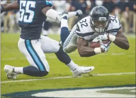  ?? The Associated Press ?? Seattle Seahawks running back Chris Carson (32) dives into the end zone for a touchdown against the Tennessee Titans during NFL action in Nashville, Tenn., last Sunday. Seattle lost 33-27 but will look to bounce back in hosting the Indianapol­is Colts...