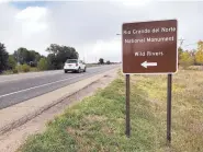  ??  ?? A sign along the Enchanted Circle Scenic Byway at Questa directs travelers to the Rio Grande Del Norte National Monument.