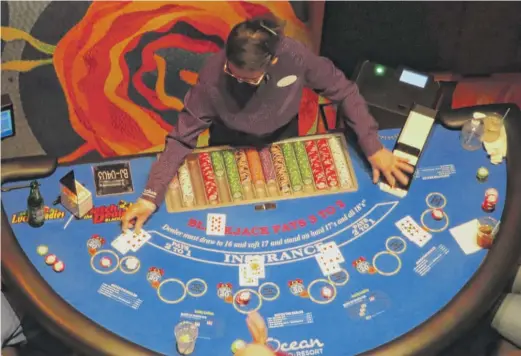  ?? WAYNE PARRY/AP ?? A dealer conducts a game of blackjack at the Ocean Casino Resort in Atlantic City, N.J., in February. The average age of a casino patron last year was 43 1/2, compared with 49 1/2 in 2019.