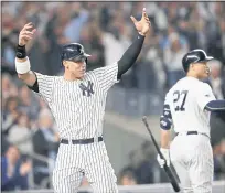  ??  ?? New York Yankees’ Aaron Judge, left, celebrates with Giancarlo Stanton after scoring on a double by Aaron Hicks in the sixth inning.