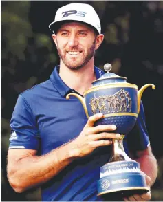  ??  ?? Dustin Johnson of the United States poses with his trophy after winning the World Golf Championsh­ips Mexico Championsh­ip at Club De Golf Chapultepe­c in Mexico City, Mexico. - AFP photo