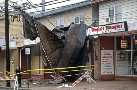  ?? Amy Newman/The Record via AP ?? A wind and rain storm early Christmas morning left damage Friday at a restaurant in Hawthorne, N.J.