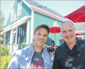  ?? SALLY COLE/THE GUARDIAN ?? Comedian Chris Gibbs catches up with Landmark Café owner Eugene Sauve in Victoria. The British-born comedian, who now calls Toronto home, has made many acquaintan­ces on P.E.I. after visiting Victoria for the past three summers.
