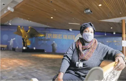  ?? JONATHON GRUENKE/STAFF ?? Wisteria Perry, manager of interpreta­tion and community outreach at the Mariners’ Museum and Park, sits inside the entrance last week. The museum is debuting “Hidden Histories” virtual programmin­g on Tuesday for Black History Month.