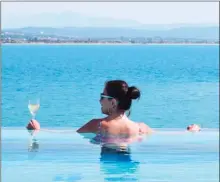  ?? The Okanagan Sunday ?? The infinity pool at the back of the new Viking Sky cruise ship is the favourite hangout of reporter Steve MacNaull and his wife, Kerry, pictured.