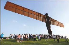  ?? The Associated Press ?? People attend a service Friday at the Angel of the North in Gateshead, England, in memory of Manchester bombing victims Courtney Boyle and stepfather Philip Tron. Boyle, a 19-year-old student at Leeds Beckett University, and Tron, 32, were picking up...