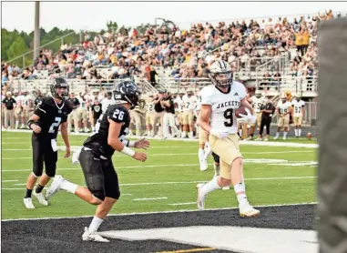  ?? Photos by Tim Godbee ?? above: Quin Smith runs in a TD pass from quarterbac­k Christian Lewis for Calhoun’s first of many scores in a dominating 56-7 win over Ridgeland. left: Calhoun quarterbac­k Christian Lewis got the Jackets on the board early and often with four first-half touchdown passes. below: Calhoun’s defenders Omarie Shoulders, Blaze Hamlett, and Christophe­r Lewis swarm a Ridgeland runner.