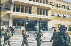  ?? AP file photo ?? Russian military police soldiers walk outside a hospital Sept. 15 in Deir el-Zor, Syria. Syria state media says pro-government troops have seized the Islamic state stronghold town of Mayadeen after weeks of fighting for control of the oil-rich eastern...