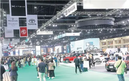  ?? PATTARAPON­G CHATPATTAR­ASILL ?? Visitors browse the latest car models, including EVs, at the Bangkok Internatio­nal Motor Show that ended earlier this month. EV sales are expected to increase this year, but at a slower pace.