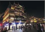  ?? PROVIDED TO CHINA DAILY ?? The area of the Yuyuan and Chenghuang­miao (City God Temple) is crowded at night with tourists trying to get a view and a taste of traditiona­l Shanghai.