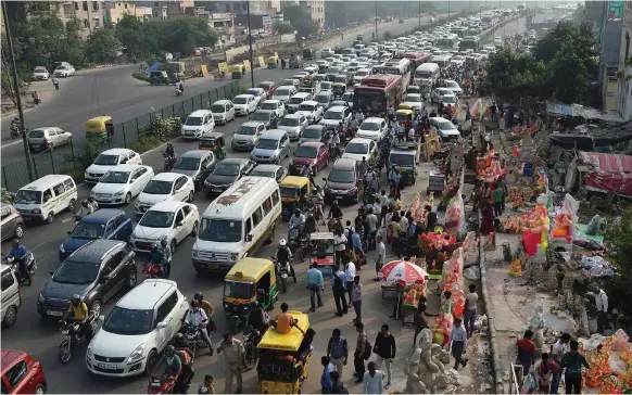  ?? AFP ?? New Delhi, above, plans to have only electric cars such as Tesla, left, on roads by 2030