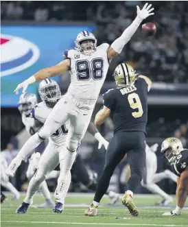  ?? [AP PHOTO] ?? New Orleans Saints quarterbac­k Drew Brees (9) is pressured by Dallas Cowboys defensive tackle Tyrone Crawford (98) during the Cowboys 13-10 victory over the Saints in Arlington, Texas, on Thursday night.