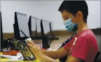  ?? LM OTERO — THE ASSOCIATED PRESS ?? Amid concerns of the spread of COVID-19, sixth grader Salih Tas wears a mask as he works on building a robot during a STEM summer camp Tuesday at Wylie High School in Wylie, Texas.