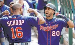  ?? Marcio Jose Sanchez The Associated Press ?? Eddie Rosario celebrates with Twins teammate Jonathan Schoop after homering in the eighth inning of Minnesota’s 16-7 win Thursday at Angel Stadium. Schoop hit two of the Twins’ team record-tying eight home runs.