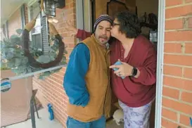  ?? MIGUEL LUNA COURTESY OF ALVARO LIZAMA KENNETH K. LAM/STAFF; HEADSHOT OF ?? Kim Luna, right, comforts neighbor Pedro Marin Luna with a small kiss as they remember another neighbor Miguel Luna who was one of the workers who died at the Francis Scott Key Bridge collapse on Tuesday. The Lunas are not related.