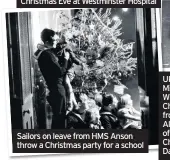  ??  ?? Sailors on leave from HMS Anson throw a Christmas party for a school