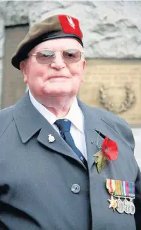  ??  ?? ●»Ken Ridings proudly wearing his war medals