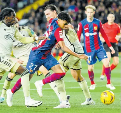  ?? AP ?? Barcelona’s Lamine Yamal (centre) fights for the ball during the Spanish La Liga match between Barcelona and Granada at the Olimpic Lluis Companys stadium in Barcelona, Spain yesterday.