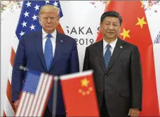  ?? SUSAN WALSH / AP FILE ?? President Donald Trump (left) meets with Chinese President Xi Jinping during a meeting at the 2019 G-20 summit in Osaka, Japan, June 29, 2019. China is not just a foreign policy issue in the November election. It runs deeply through the troubles with coronaviru­s.
