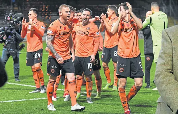  ??  ?? United players celebrate their second derby win of the season – and moving nine points clear of their city rivals.