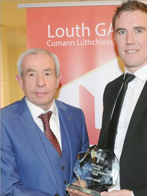  ??  ?? Louth manager Pete McGrath presents the Senior Footballer of the Year award to Bevan Duffy, St Fechin’s at the Louth GAA awards night in